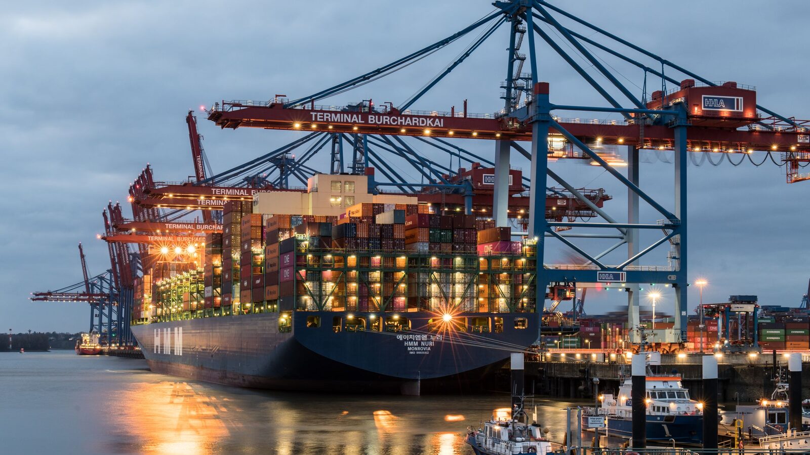 Container ships moored at a port terminal at dusk